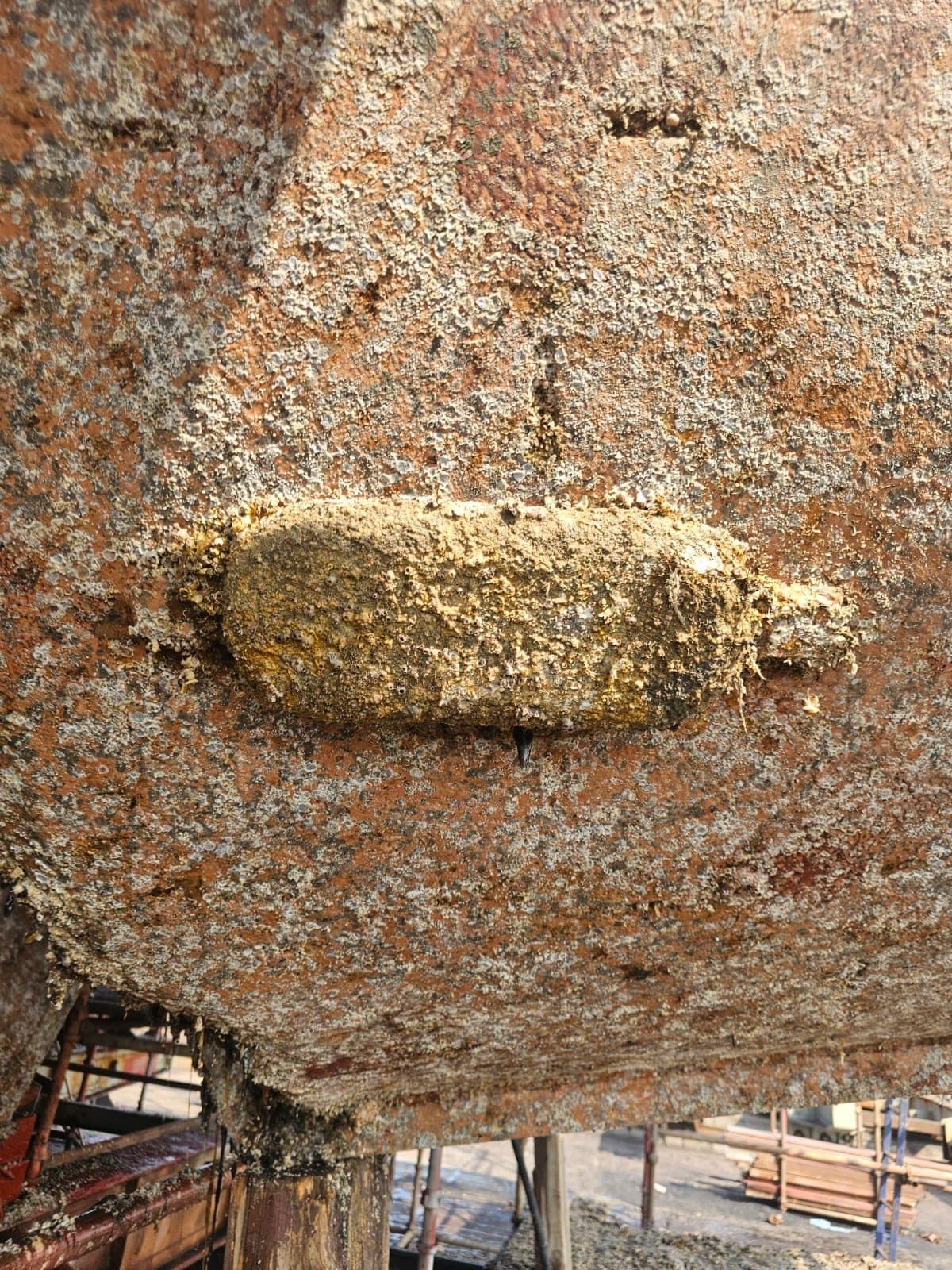 A consumed sacrificial anode on corroded steel